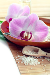 Obraz na płótnie Canvas Spa concept with bath salt and orchids, closeup shot