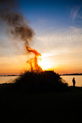 silhouette of a bonfire and a person