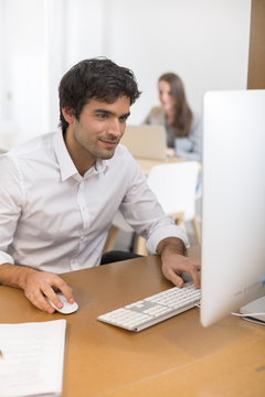 Portrait of businessman working on computer in office
