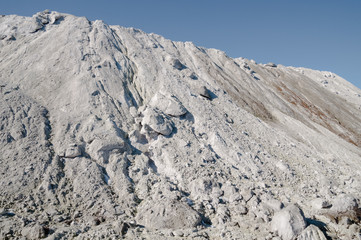The limestone hillside on the background of blue sky