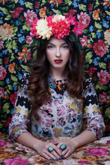 Portrait of a beautiful blonde woman with flowers in her hair. 