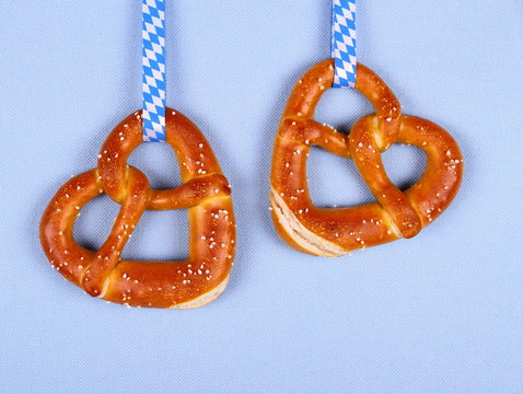 Two pretzel in heart shape on blue background