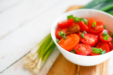 Colorful tomatoes on board on wooden background