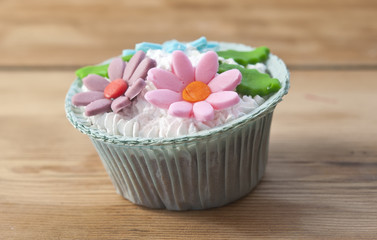 beautiful muffins decorated with spring flower on vintage wooden
