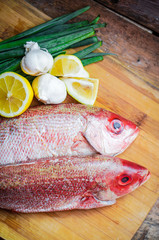 Fresh red snapper preparation with lemon and vegetables