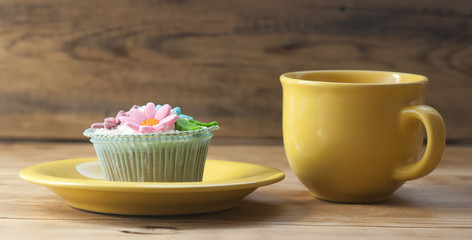 beautiful muffins decorated with coffee cup on vintage wooden ba