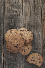 Oatmeal cookies with raisins on vintage wooden background