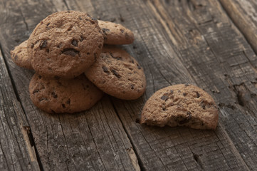 Oatmeal cookies with raisins on vintage wooden background