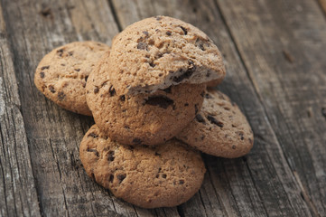 Oatmeal cookies with raisins on vintage wooden background