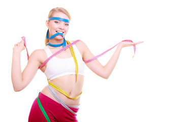 Obsessed fitness woman with a lot of colorful measure tapes