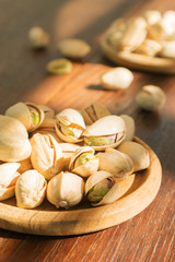 Pistachios on wooden plate