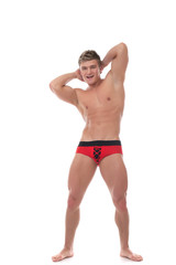 Fototapeta na wymiar Cheerful muscular guy advertises underwear