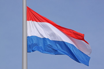 Fototapeta na wymiar flag of Luxembourg over blue sky