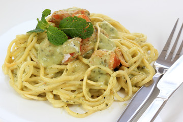 Spaghetti and salmon in pesto sauce