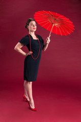 Pinup Girl in Black Dress Haughty with Red Parasol