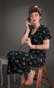 Pinup Girl in Flowered Outfit Waits on the Line