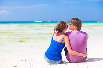 happy young couple in bright clothes in sunglasses