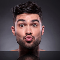 head of kissing young man