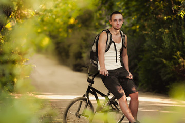 Naklejka premium Young man sitting on bike