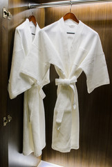 Bathrobes in the closet in the hotel.