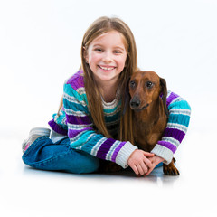 happy little girl with her ​​dachshund