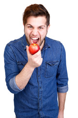 Young man eating fresh apple