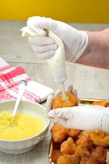 Preparazione delle frittelle di carnevale ripiene di crema
