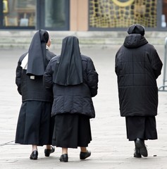 three sisters with black suit walking