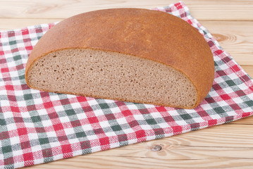 Loaf of bread on a wooden table.