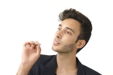 Young beautiful businessman smoking a cigar, tabacco addiction