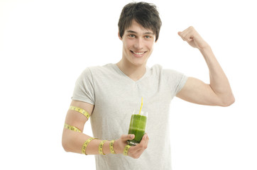 Man measuring his biceps with centimeter while drinking smoothie