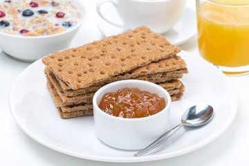 fresh breakfast - crisp bread with jam, orange juice and muesli