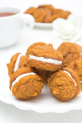 Pumpkin cookies with cream filling, close-up
