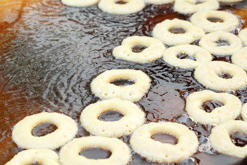 making donut fried in a pan
