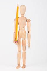 Small wood mannequin standing with colour pencil isolated on whi