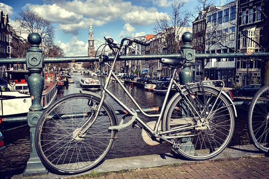 Old bicycle on bridge. Amsterdam cityscape