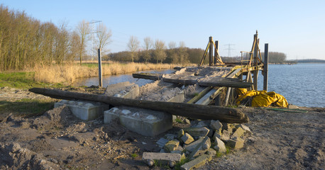 Ruined bridge on the shore of a lake