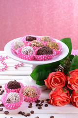 Fototapeta na wymiar Set of chocolate candies on table on pink background