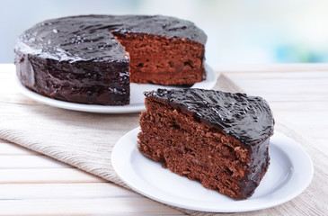 Delicious chocolate cake on plate on table on light background