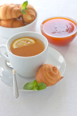 Apricot jam pastries and tea with lemon