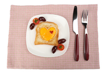 Scrambled eggs with bread on plate, on color napkin