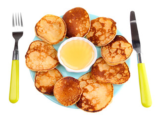 Fried pancakes on color plate, isolated on white