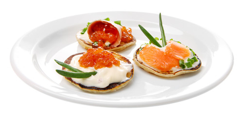 Pancakes with red caviar and salmon,  isolated on white
