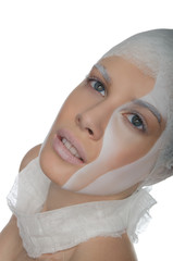 Portrait of young woman with face art and bandage