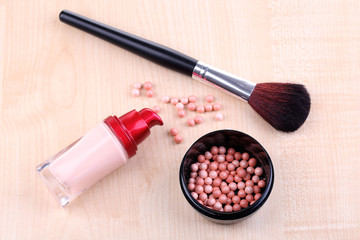 Composition with concealer, powder balls and brush
