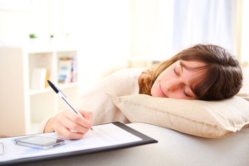 Young pretty girl sleeping while working home