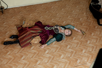 girl in medieval dress posing on background the interior