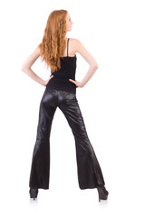 Fototapeta premium Redhead woman in black bell bottom pants on white