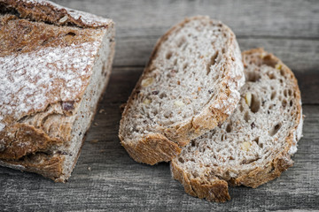 Sliced brown bread on wooden table.