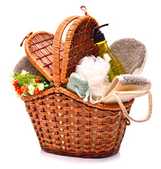 Natural bath sponges, pumice, gel and flowers in the basket